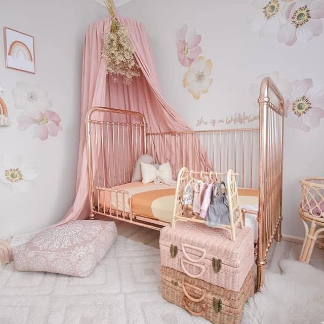 Best Baby Girl Nursery Ideas with pastel nursery décor and a light pink toddler bed as the centrepiece.
