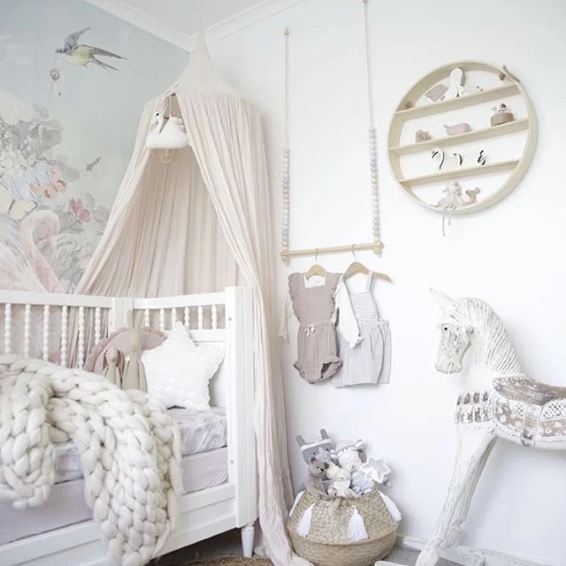 White toddler bed featured in a cosy nursery layout, part of the Best Baby Girl Nursery Ideas