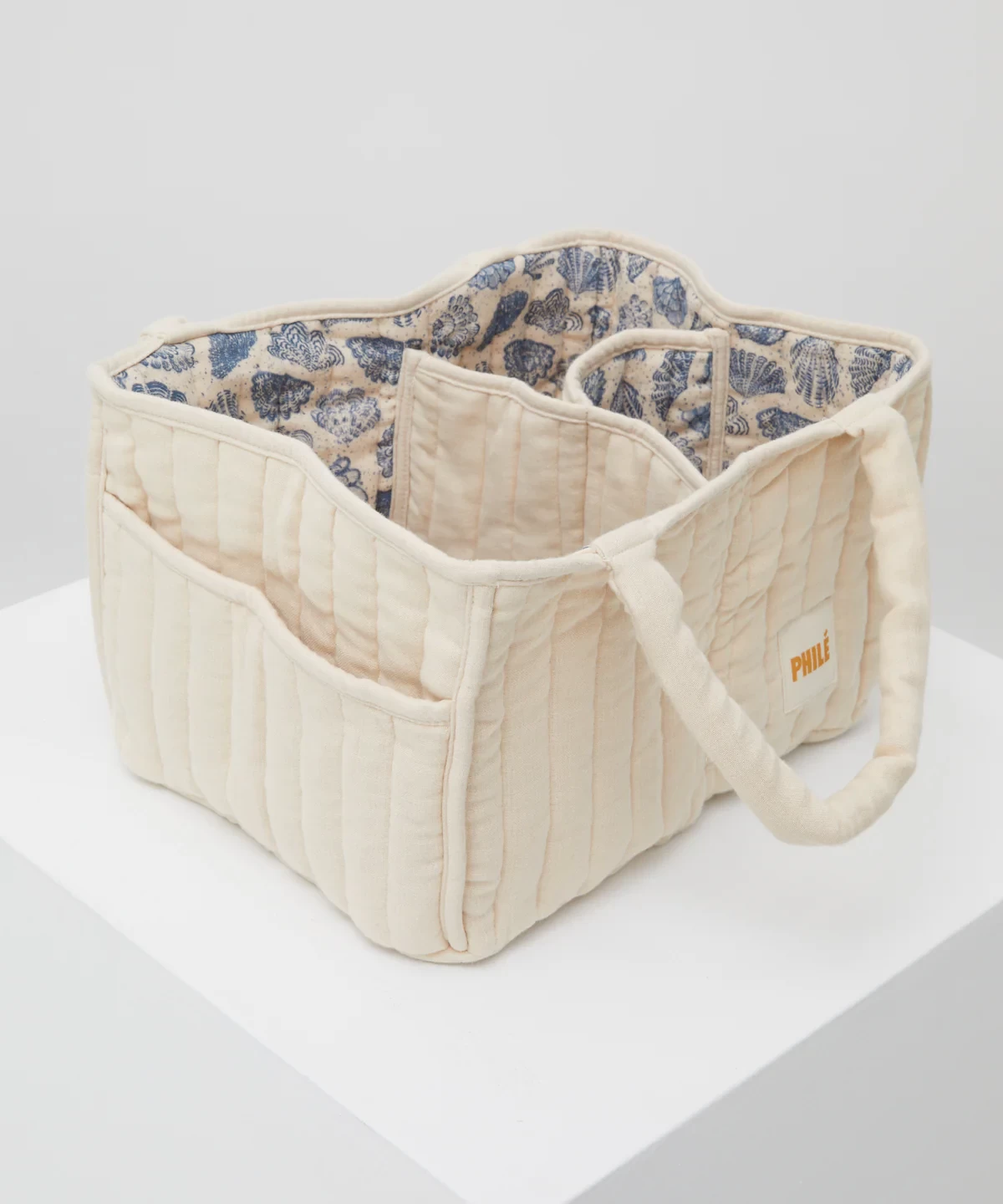 Phile Nappy Caddy shown with ocean shell print interior and cream exterior