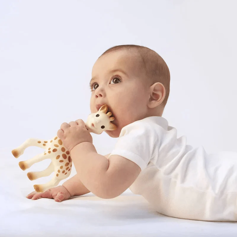 The sophie la girafe teether shown with a baby