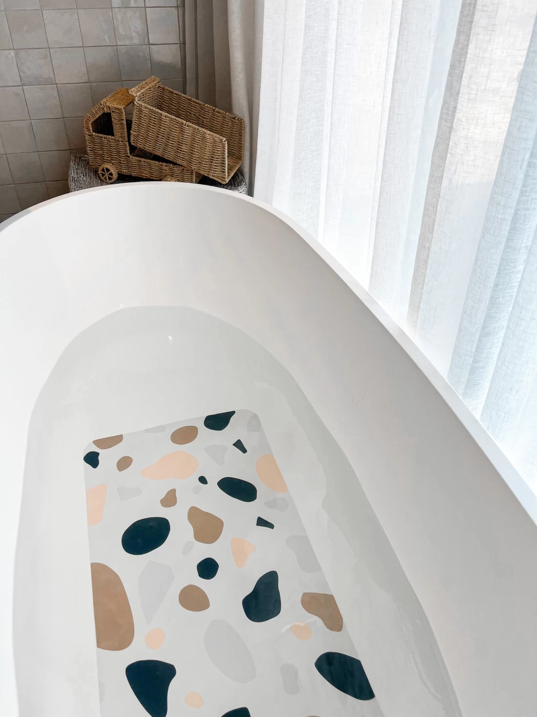 Best bath mat draped over the tub with water, showing absorbent texture and quick-dry design.
