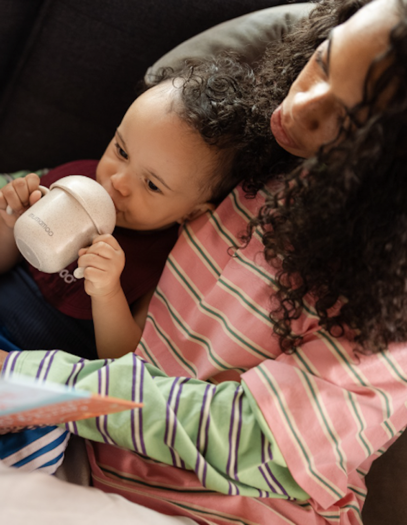 A toddler having toddler milk in Australia with his mother