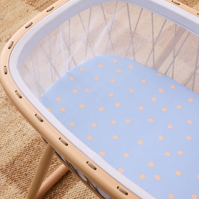 Blue polkadot bassinet sheet on a bassinet
