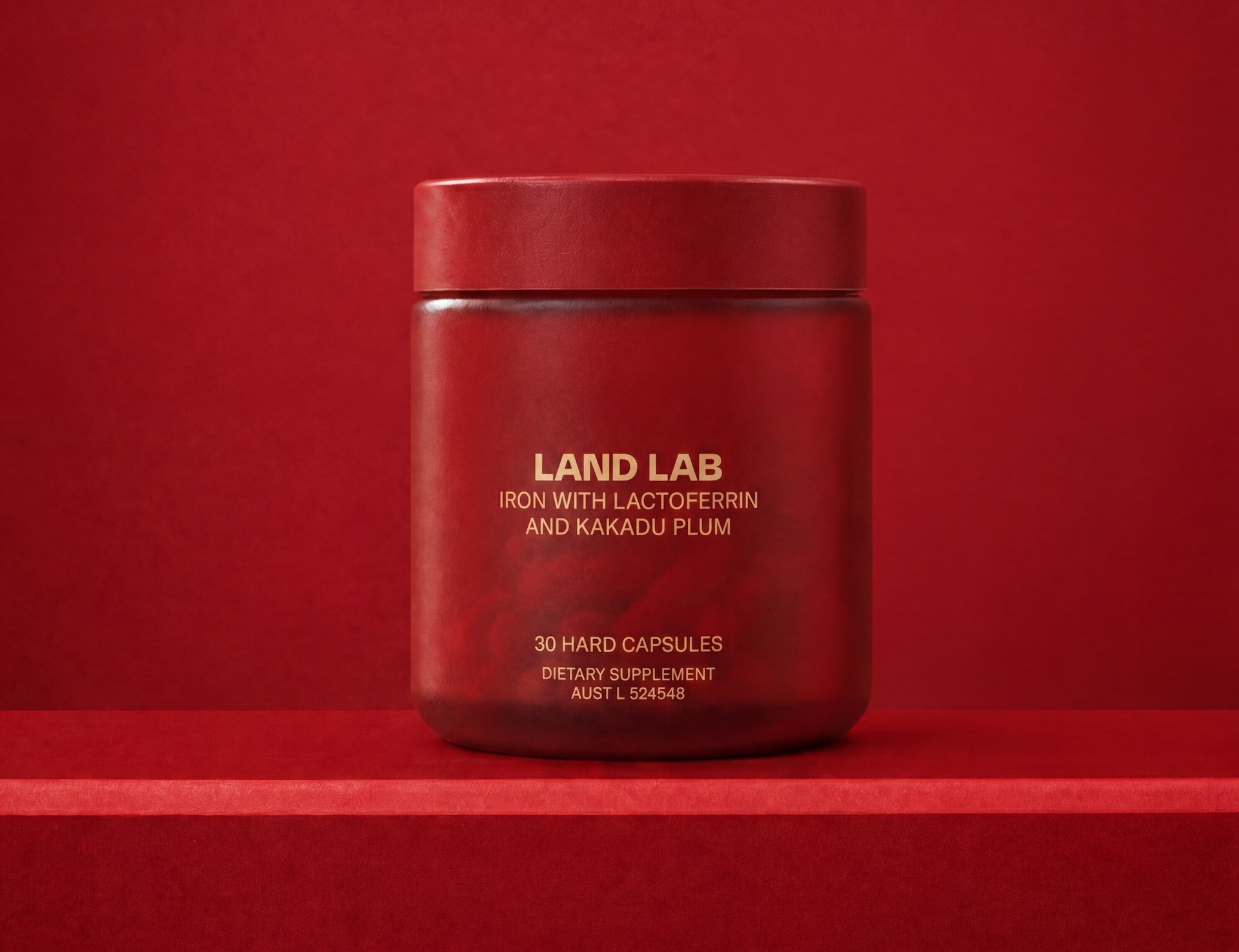 The Land Lab iron supplement shown on a red background