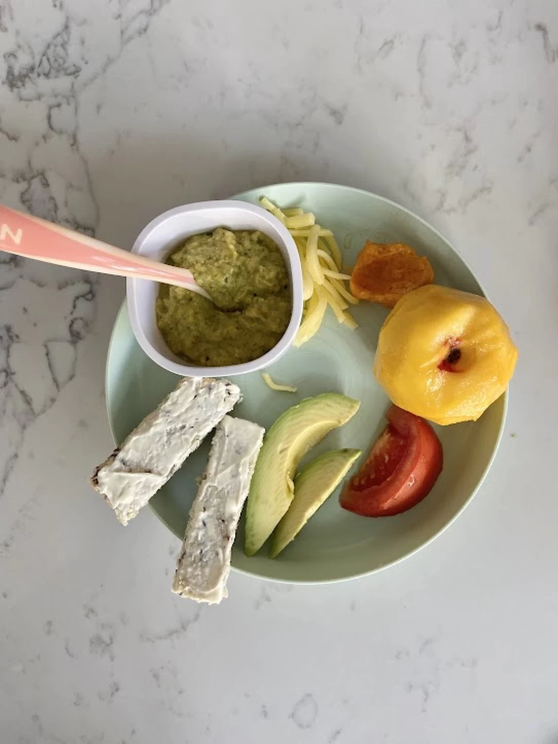 Close-up top view of colourful healthy foods for baby, supporting parents in introducing solids to baby.