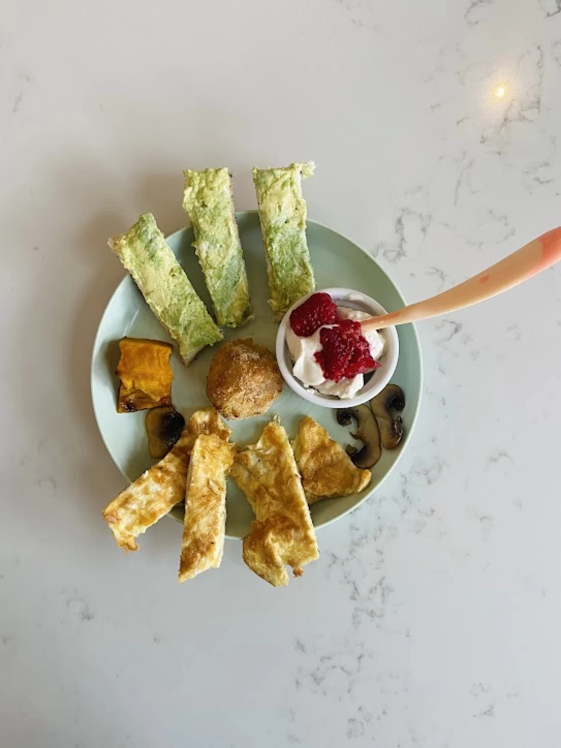 Assortment of nutritious foods for baby from a top view, illustrating tips for introducing solids to baby.