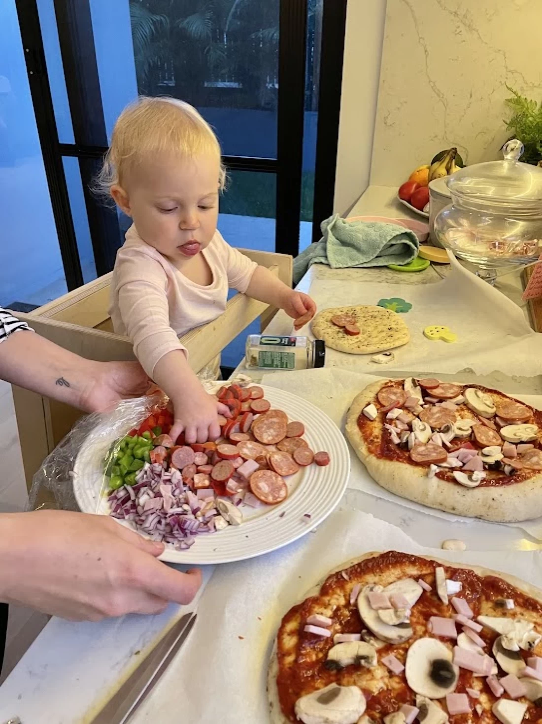 Baby exploring food on the table, part of a practical guide for introducing solids to baby.