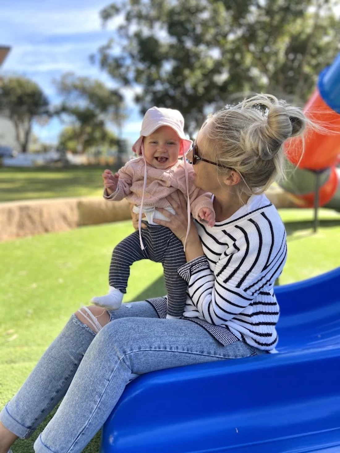 Australian mum outdoors with baby, illustrating everyday moments related to introducing solids to baby
