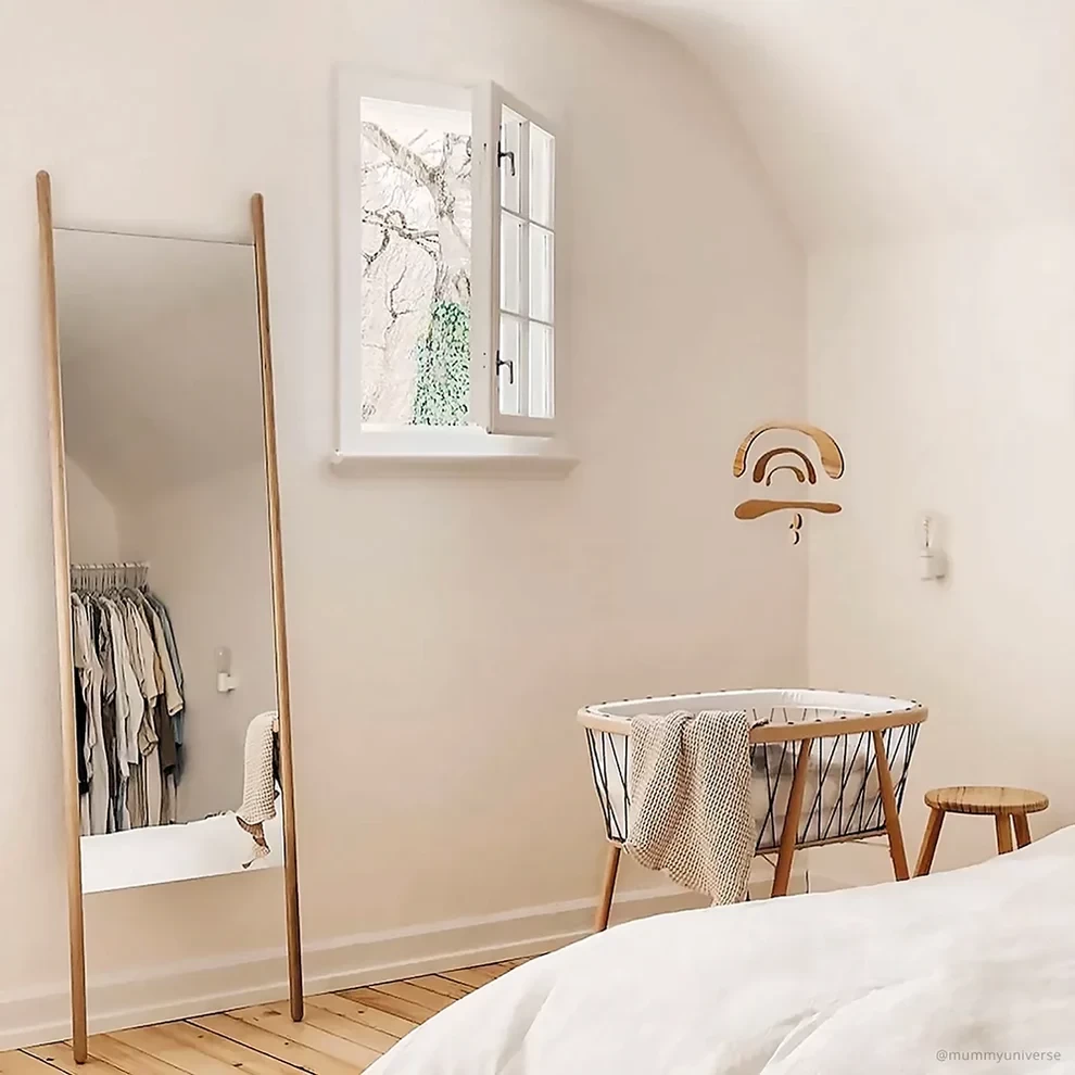 The Charlie Crane baby bassinet shown in a minimalist bedroom