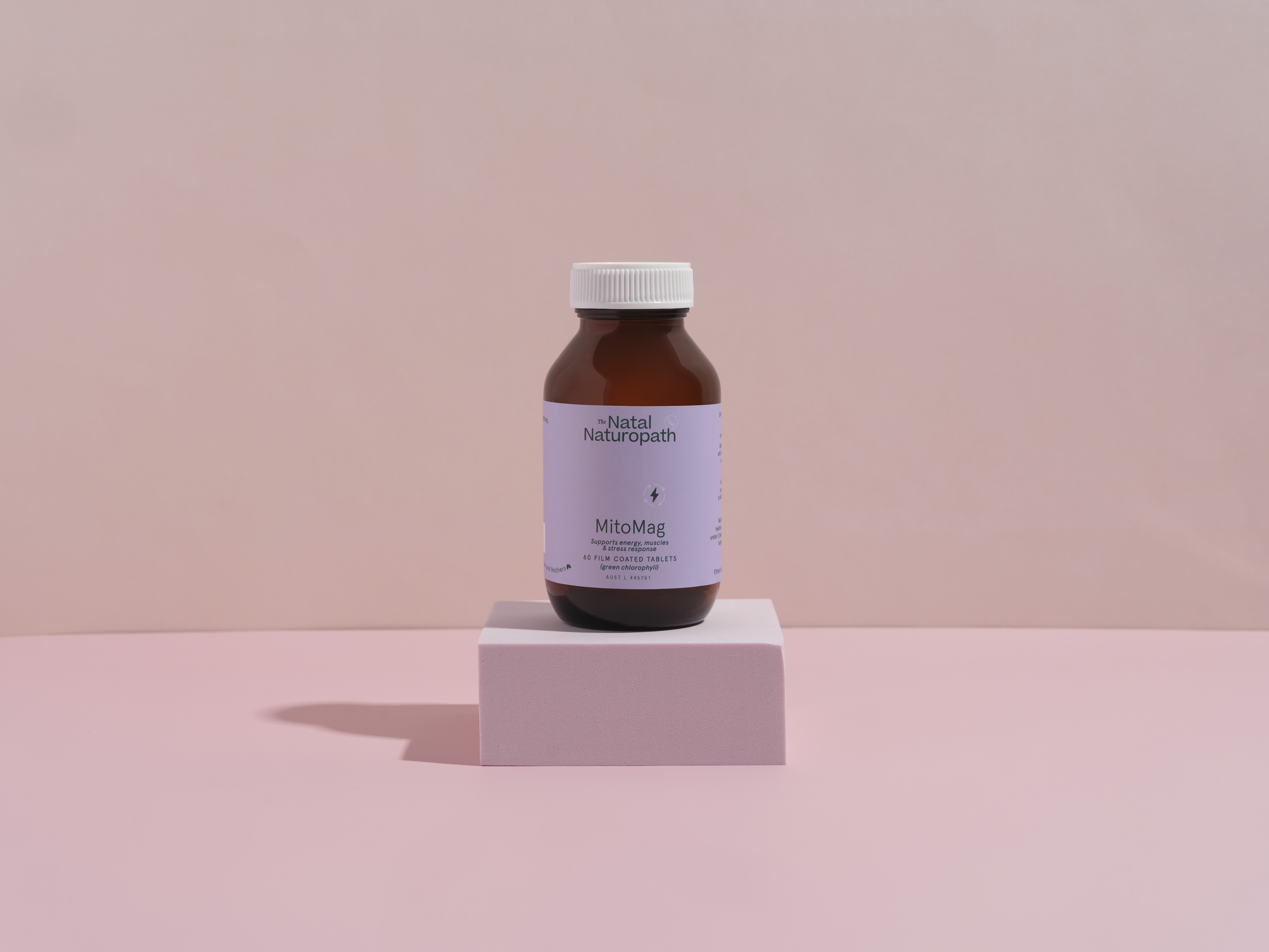 Single bottle of The Natal Naturopath MitoMag best energy supplement on a pink background, promoting natural energy boost.
