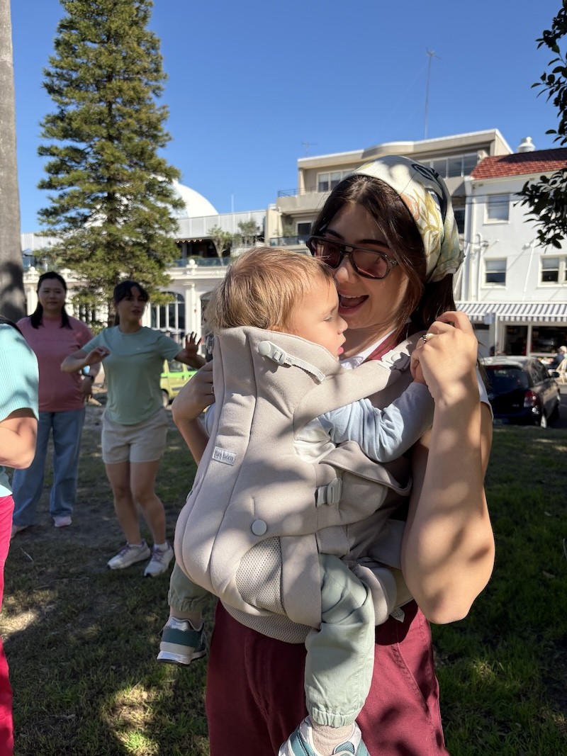 A mum using the babybjorn baby carrier hold with her baby in it