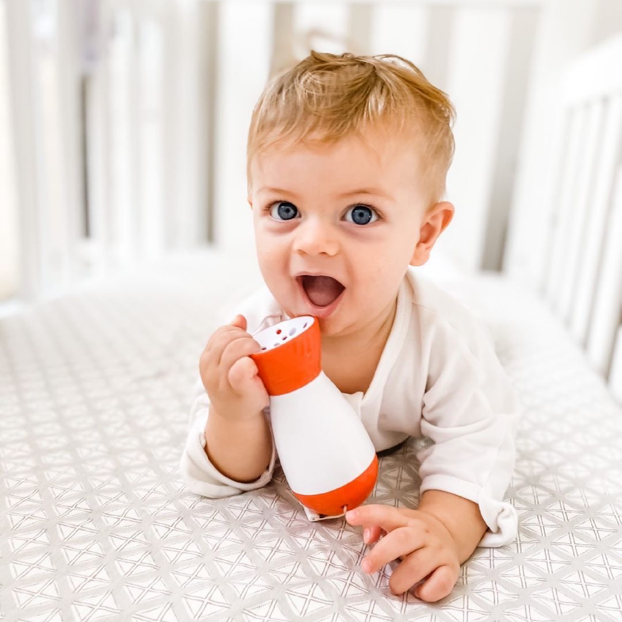 Baby shusher sleep aid held by a baby while resting, showing comfort with the white noise machine.