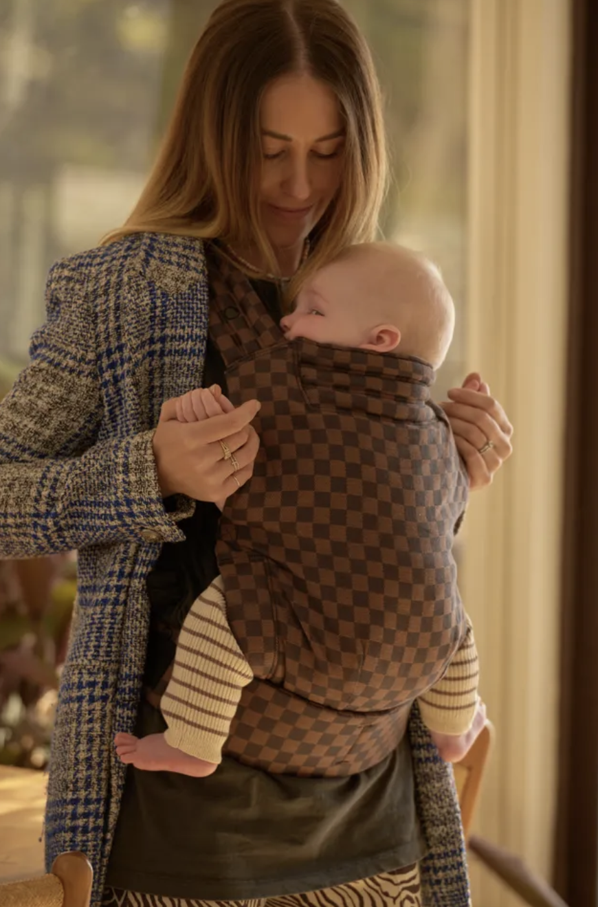 Best baby carrier by Tote Studio offering ergonomic support as mum carries her baby.