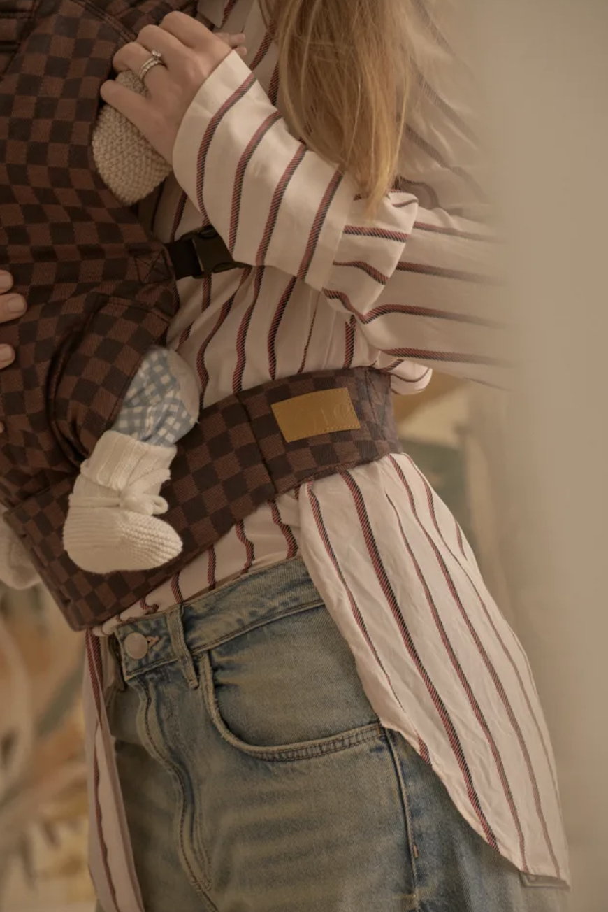 Close-up of a mum wearing The Tote Studio, the best baby carrier for secure and stylish babywearing