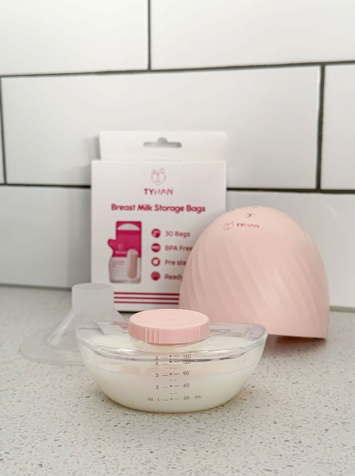 The Tyhan Elevate Wearable Breast Pump and breastmilk storage bags on the kitchen countertop