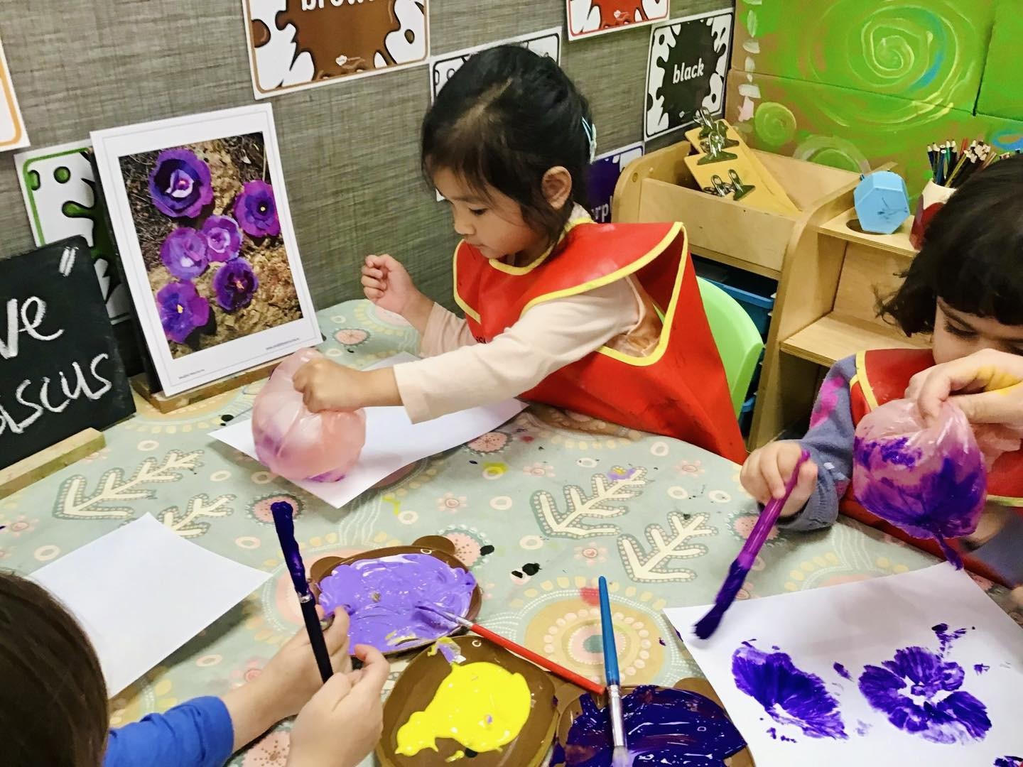 Creative art session with toddlers painting at the best childcare and daycare centre in Australia.