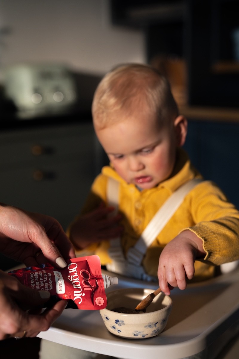 A baby enjoying the odi nutrition baby food pouch when starting solids
