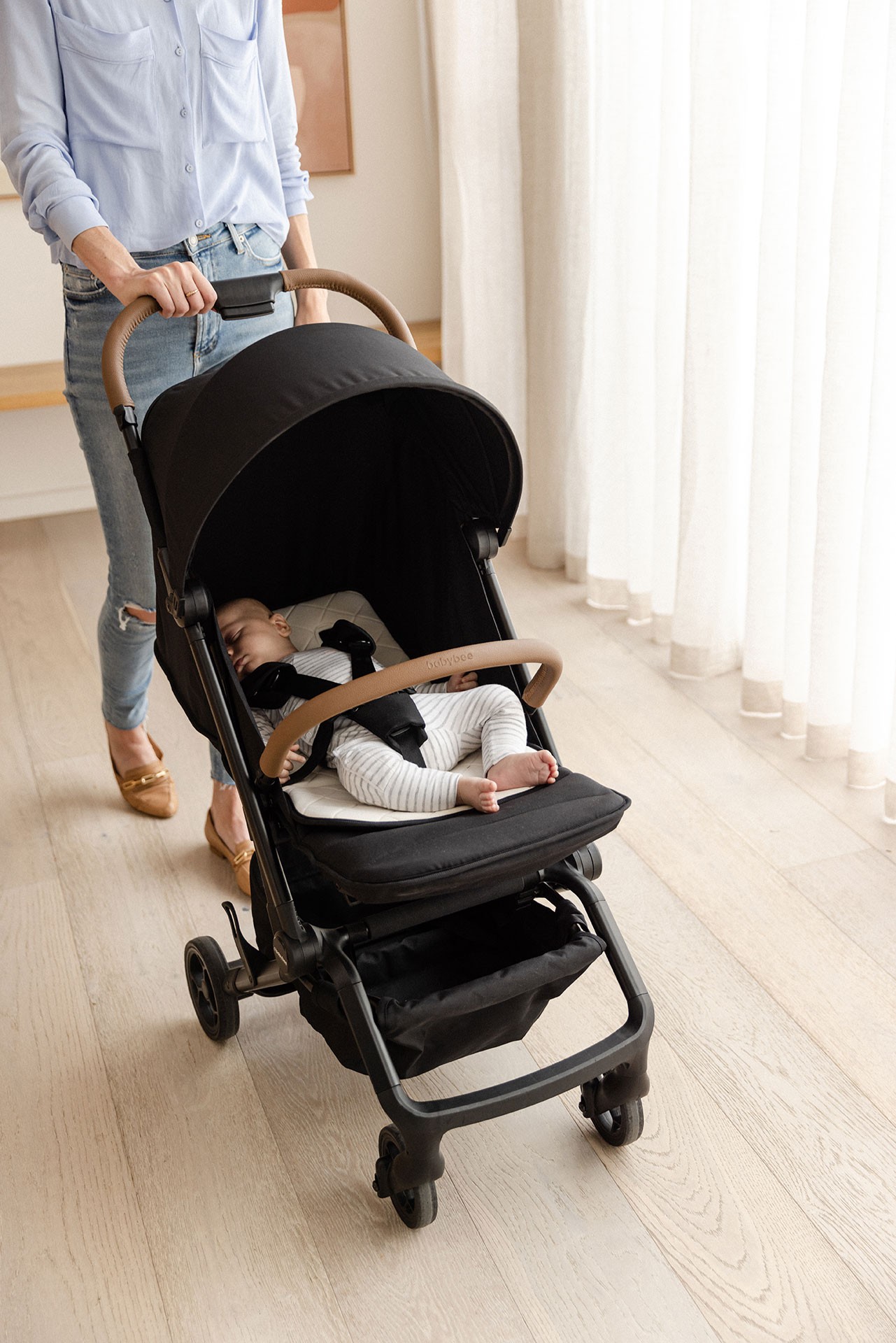 Baby asleep in the Miles travel pram in Australia