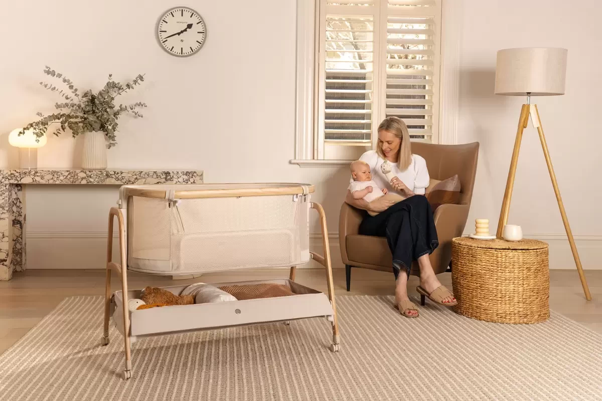 a mum with her baby and a bassinet, a baby registry item worth considering