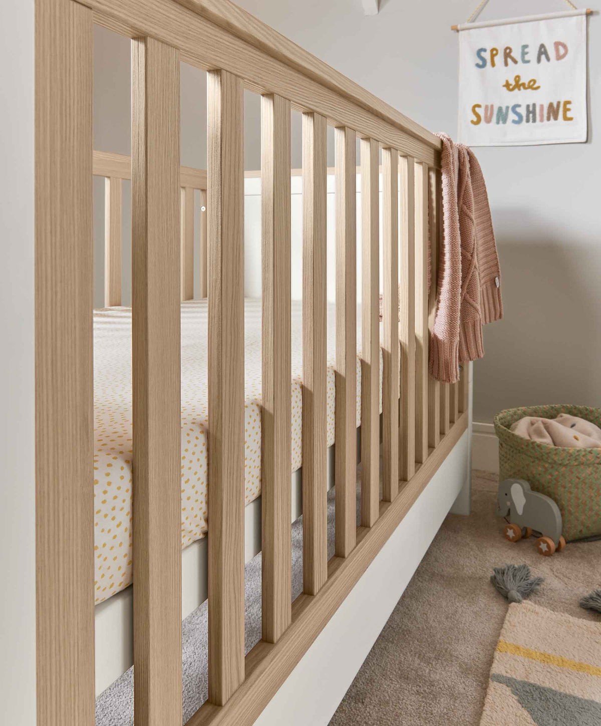Focused detail of Mamas & Papas Harwell Baby Cot Bed White Oak inside a white crib showcasing design features