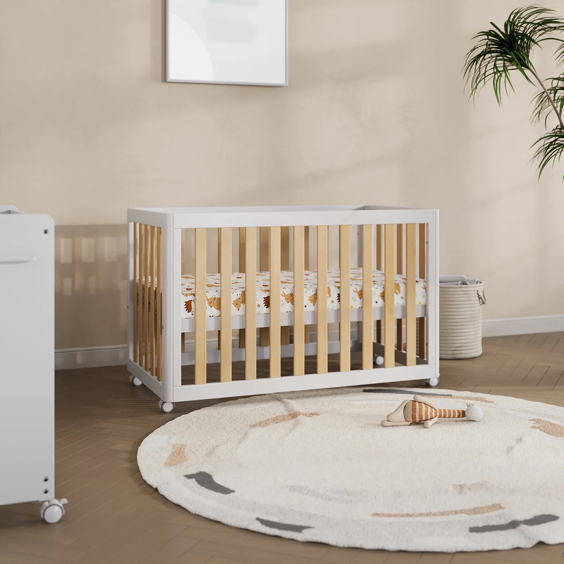 The Boori Turin Compact cot in a nursery space, in white and wood