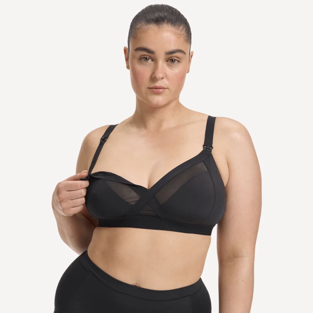A mum wearing the Nala maternity bra and showing how the strap unclips from the cup