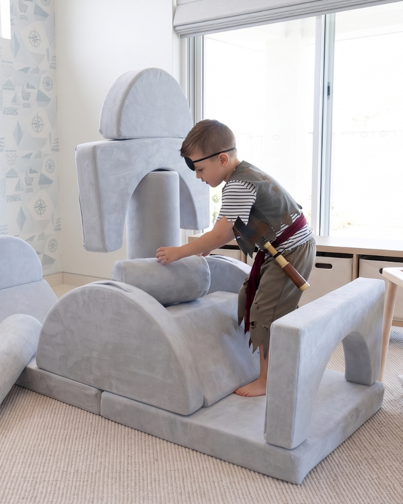 A boy on the loungey play couch