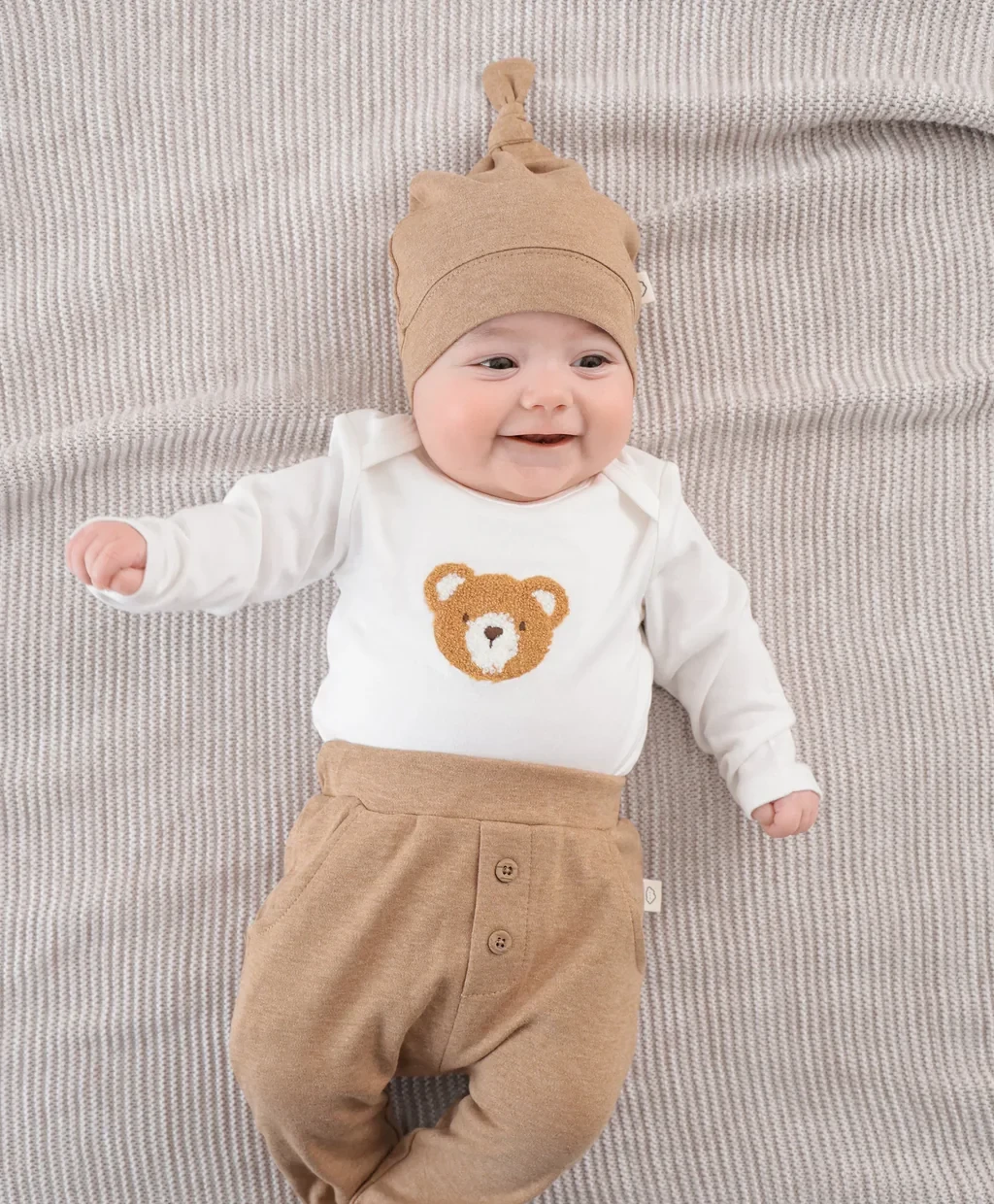 A baby in a bear outfit