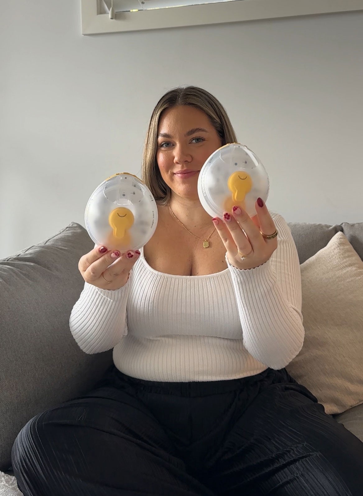 Breastfeeding Australian mum showcasing wearable Medela breast pump for hands-free expressing at home.