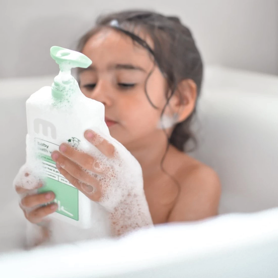 Bath time with toddler holding Milkco Baby Cream and Wash – effective best eczema cream for babies