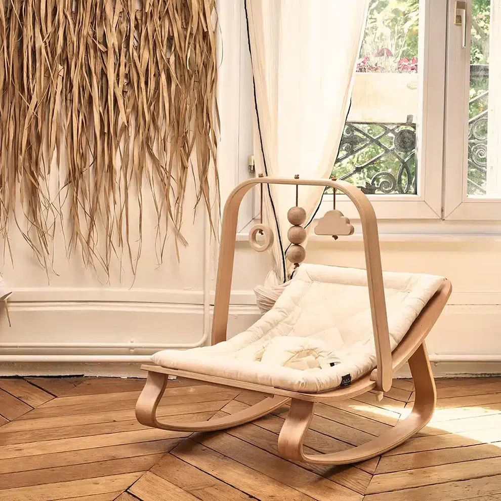The Charlie Crane baby rocker in a minimalist room with sunlight shining on it