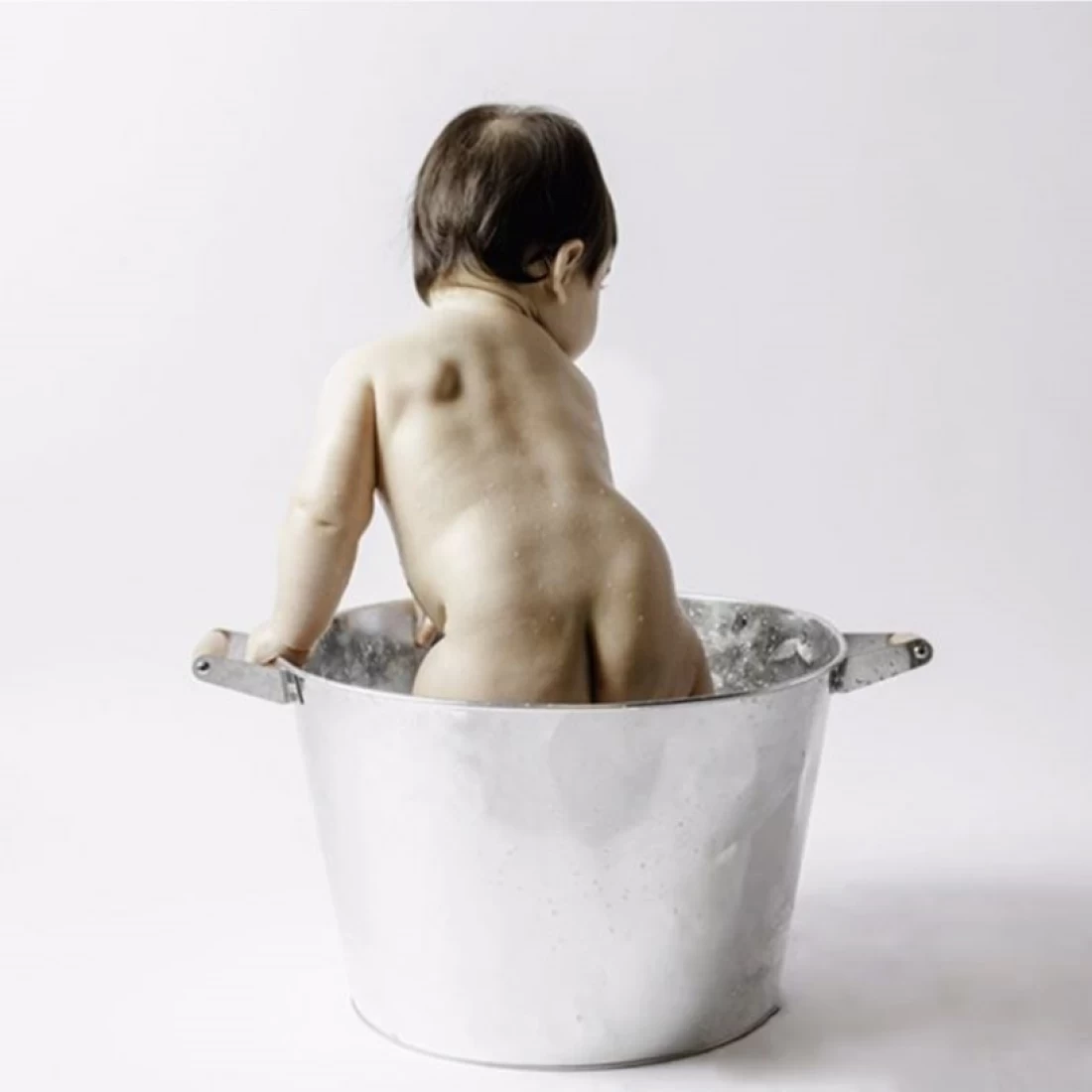 Blog banner showing a baby on a minimalist background, introducing the guide on Unsafe Baby Products to Avoid
