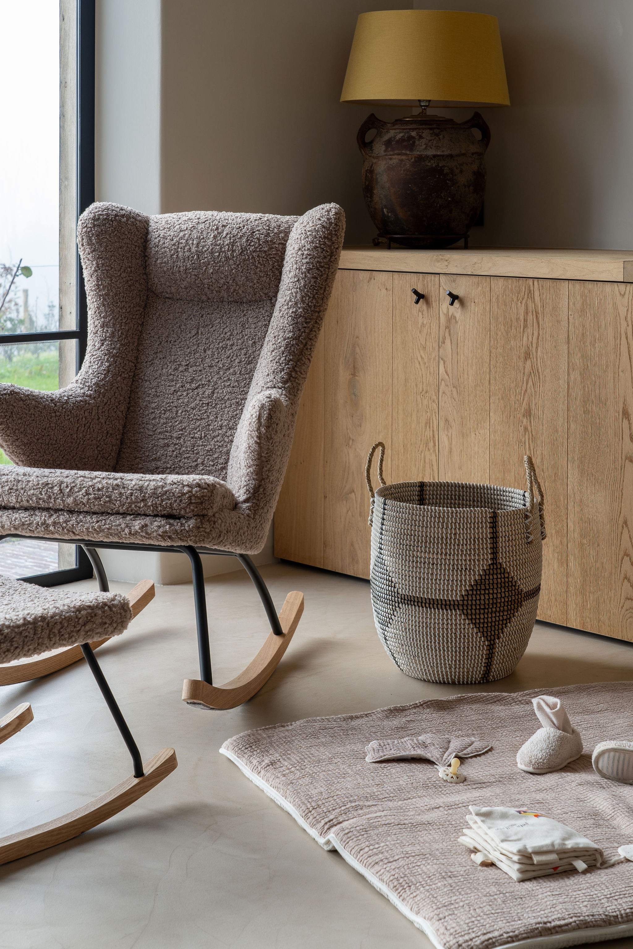 Close-up shot of the Quax Deluxe Rocking Nursing Chair with textured fabric, known as one of the best rocking nursing chairs in Australia.