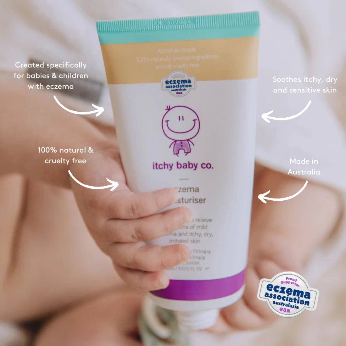 Holding a baby with Itchy Baby Co Eczema Moisturiser, the best eczema cream for babies, label clearly shown
