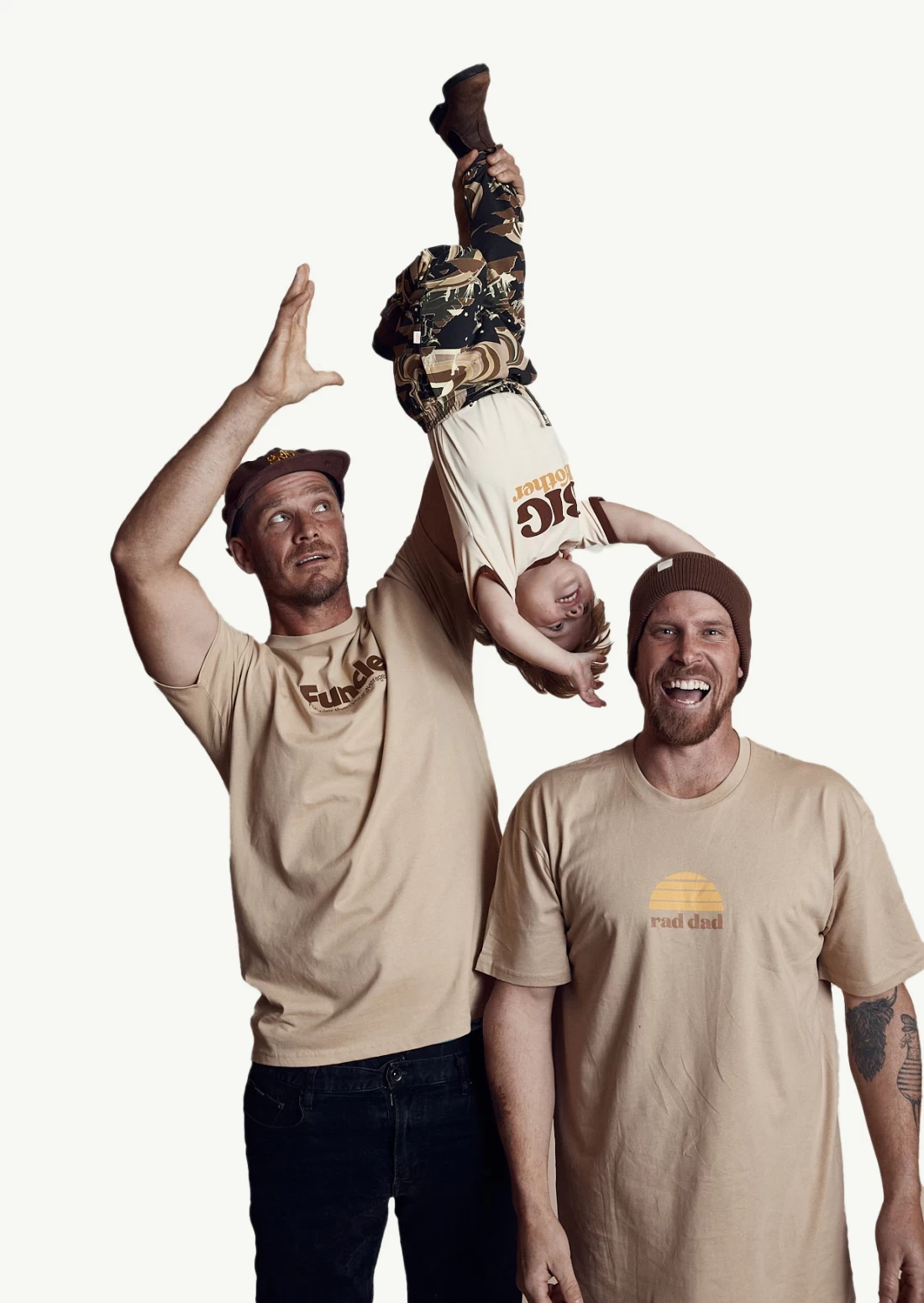 Two dads smiling with their child in matching shirts, showing the joy of the Best Father’s Day Gift.