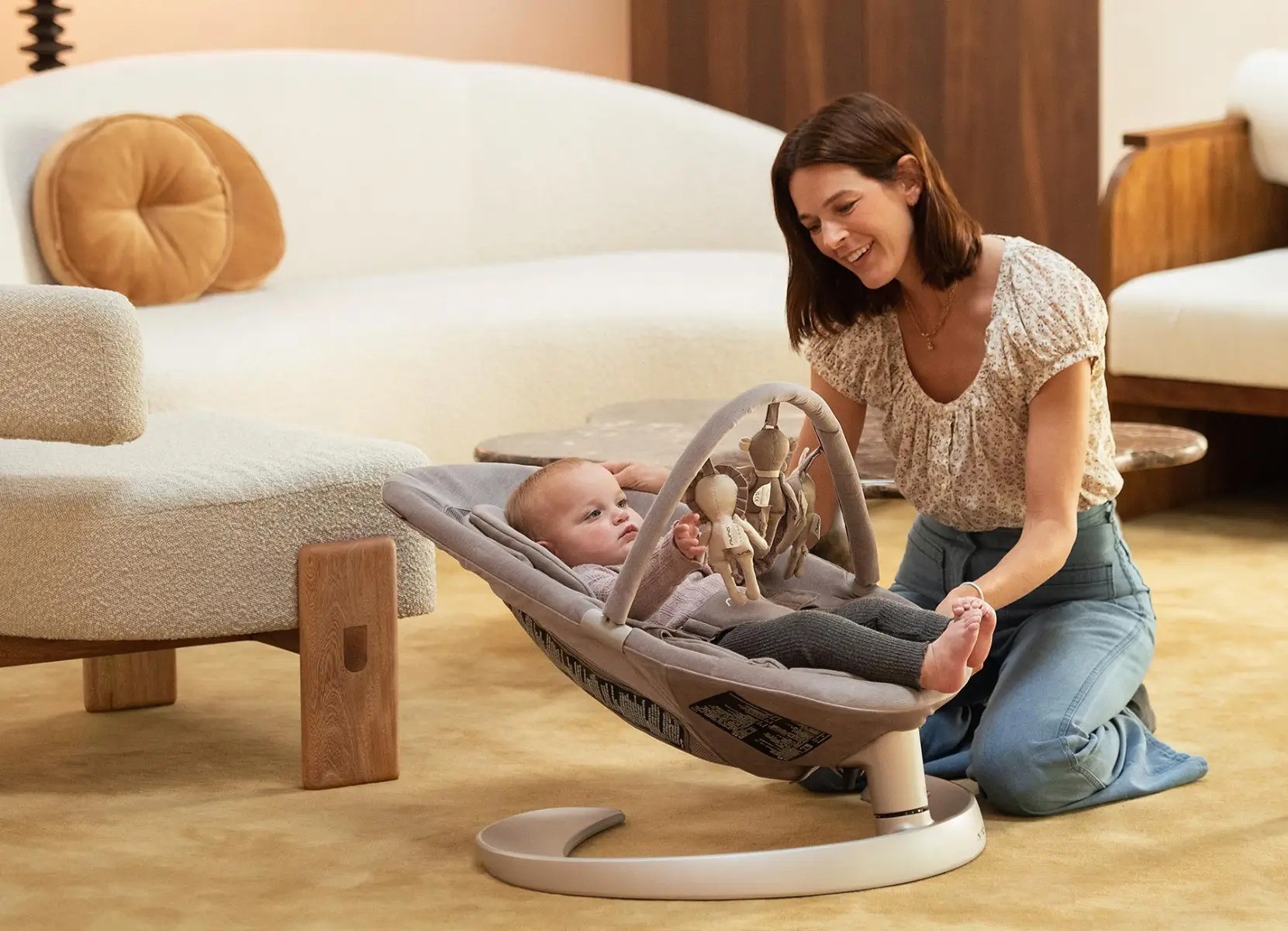The Nuna Leaf Griw baby rocker with a mum rocking her baby in it