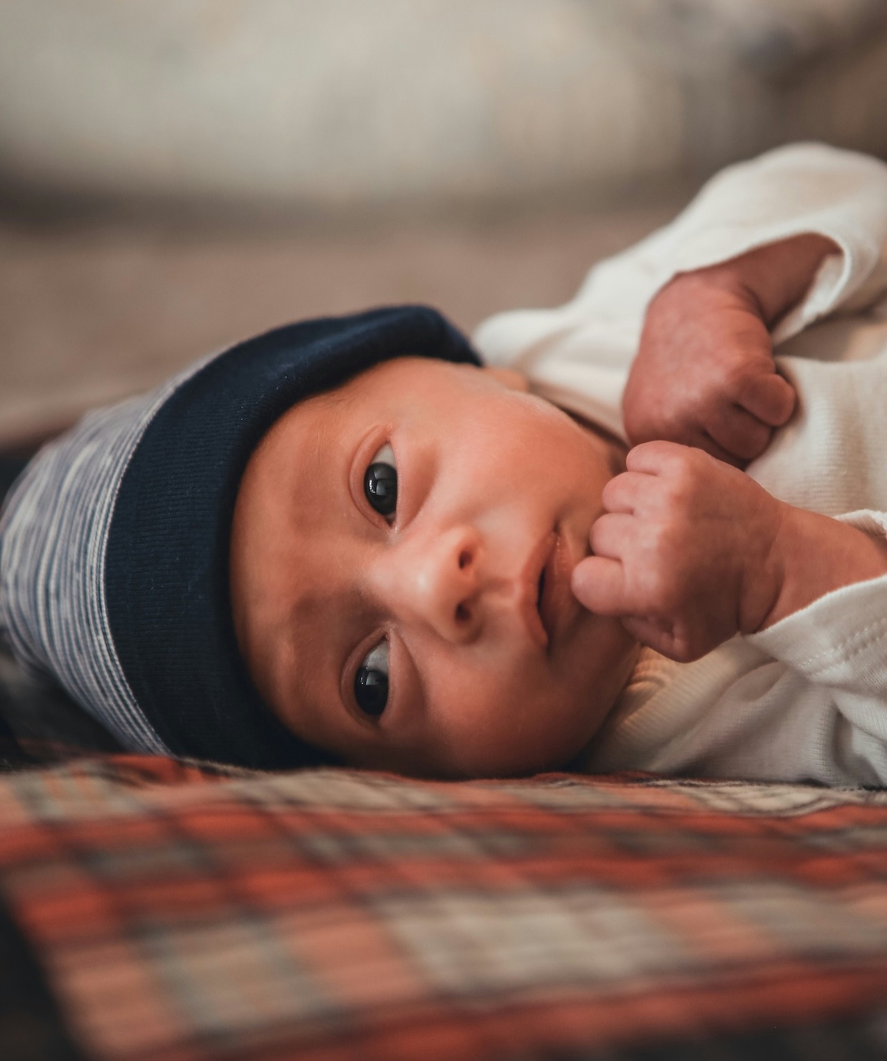 a newborn baby looking at the camera