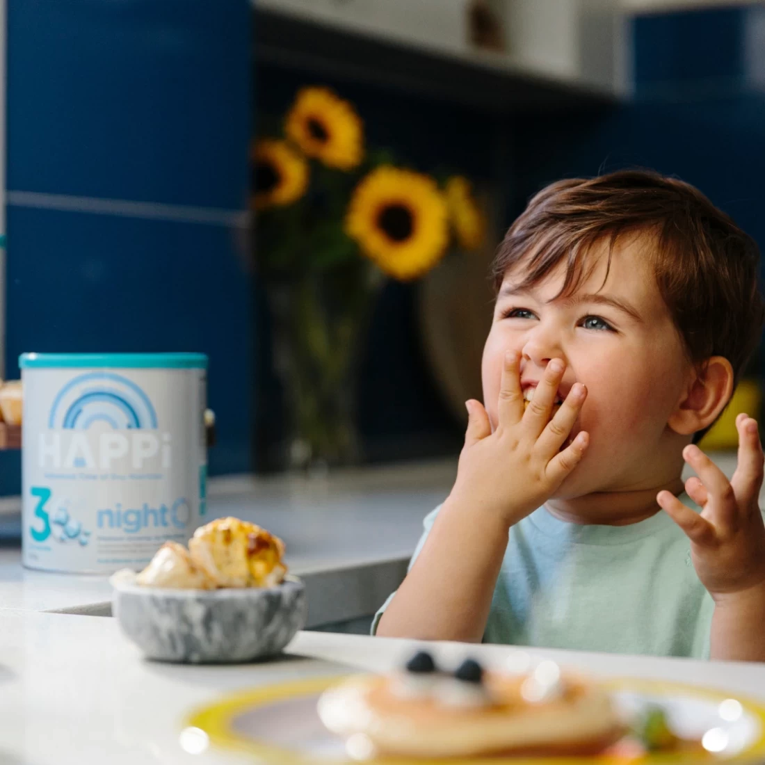 Smiling baby with HAPPi Premium Growing Up Milk Drink placed nearby – trusted by Aussie families as the best baby formula.