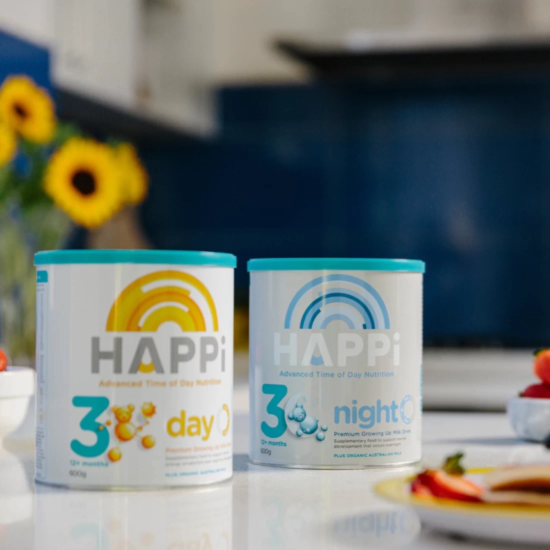 Two cans of HAPPi Premium Growing Up Milk Drink – one for day and one for night, a premium choice for the best baby formula.