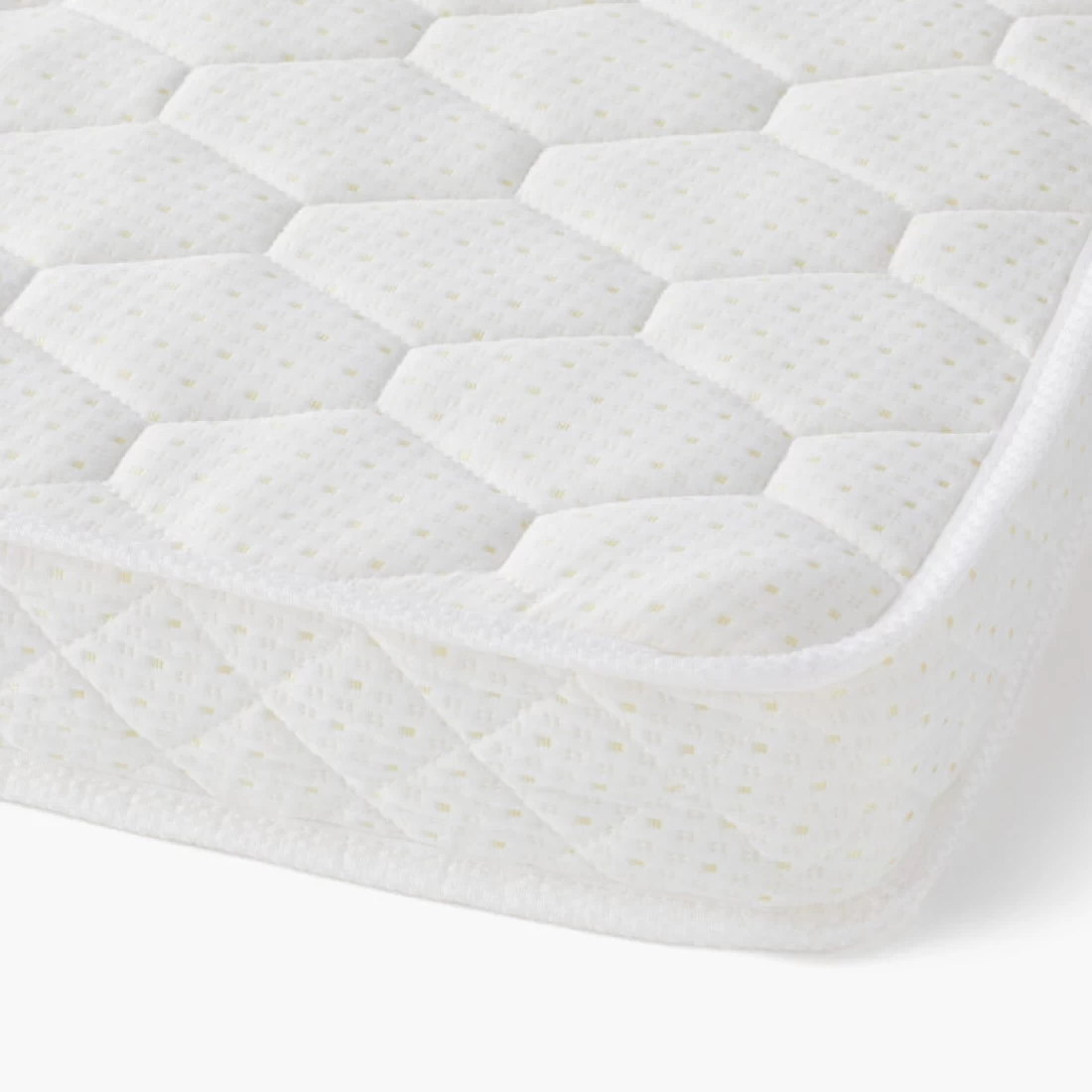 Close-up of the best cot mattress in white on a white background, showcasing soft cushioning