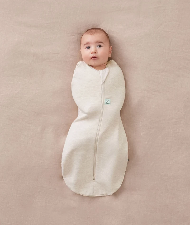 A newborn baby in a summer sleeping bag by ergopouch