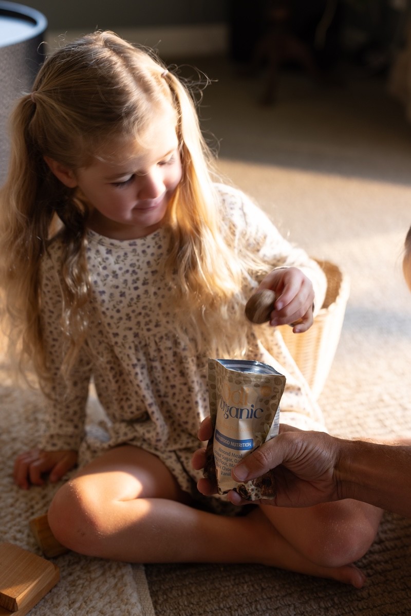 A toddler enjoying Odi Nutrition baby food snacks