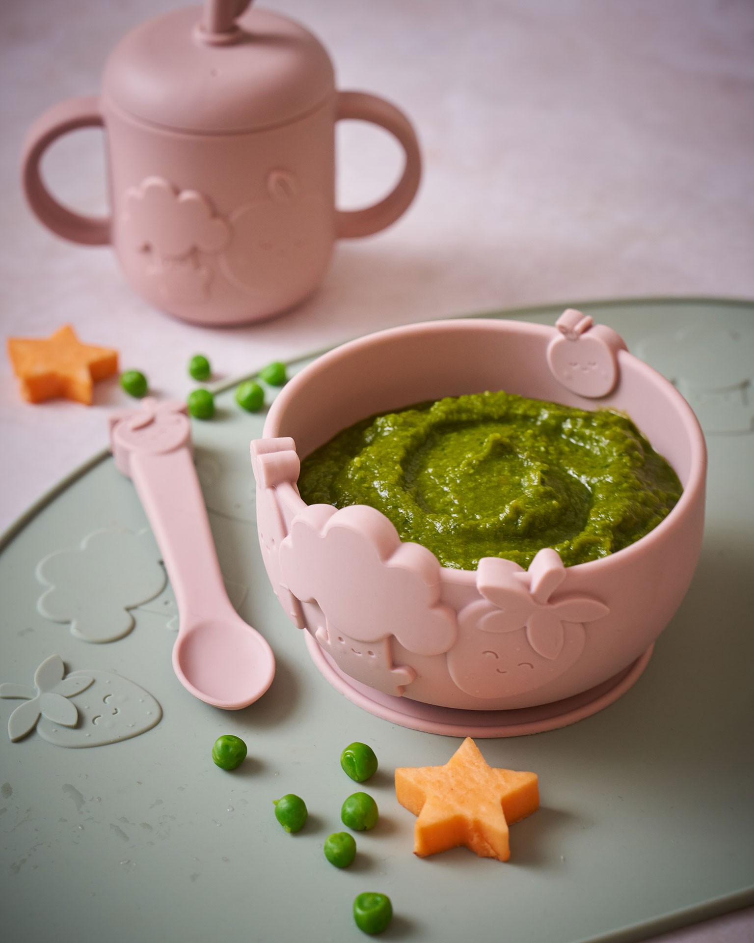Vegetable purée served in a silicone bowl with a spoon and matching sippy cup, offering simple baby food ideas from the Grow by Annabel Karmel feeding essentials collection