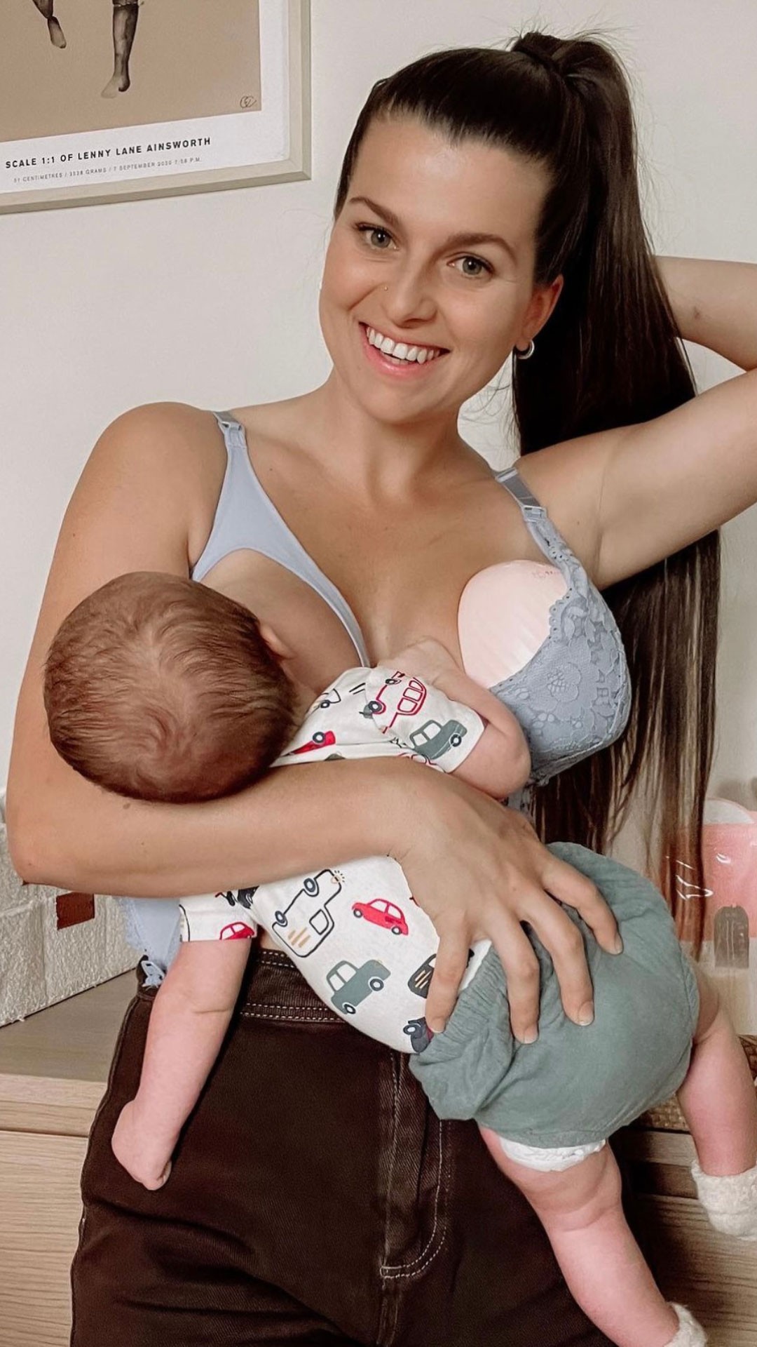 A woman breastfeeding her baby while pumping using tyhan elevate breast pump