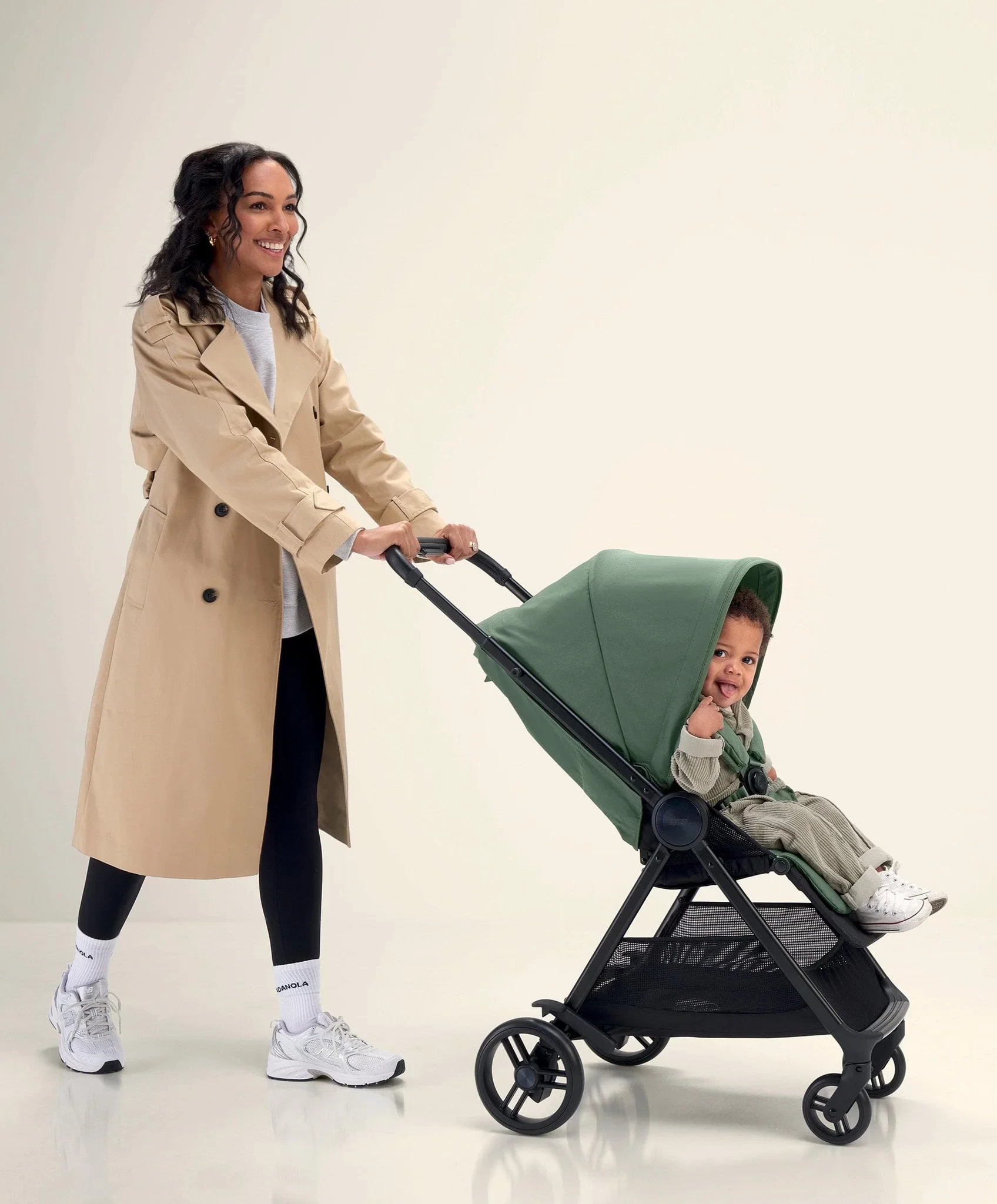 A mum walking her baby in the Libro travel pram in Australia