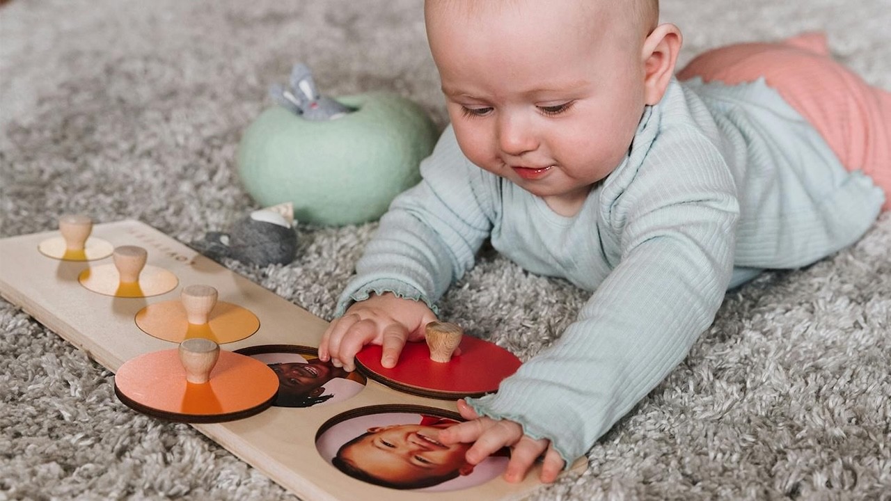 Lovevery The Babbler play kit for one year olds, shown with a baby playing