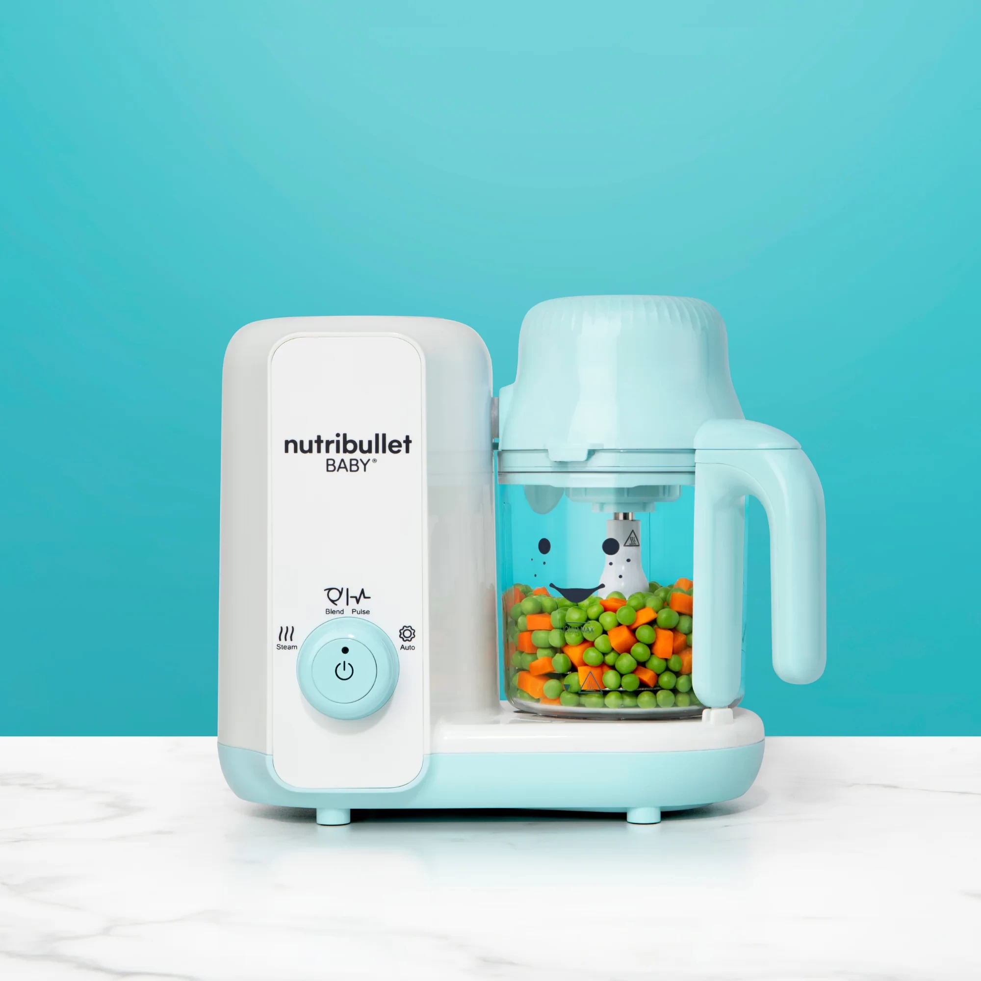 The nutribullet baby steam and blend shown with carrot and peas in