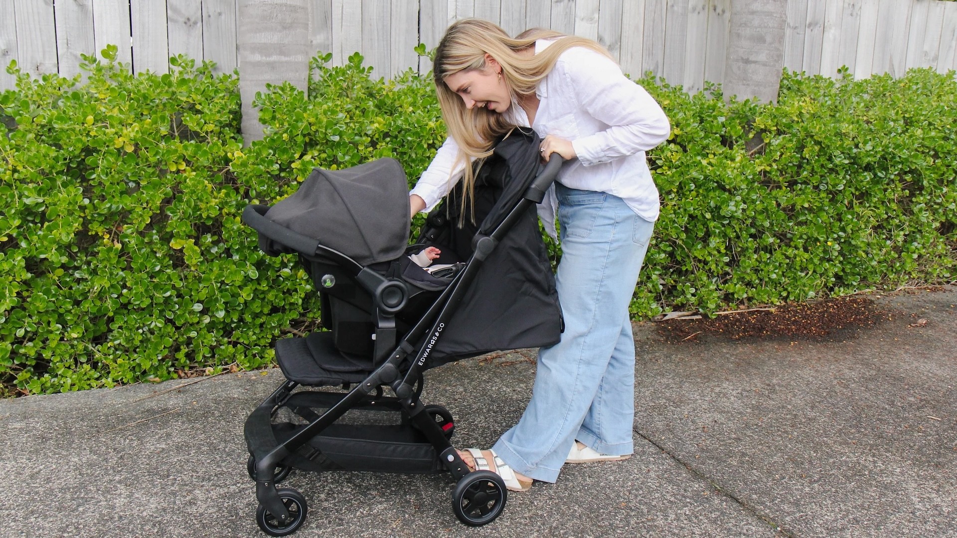 A mum talking to her baby who is in the Lucci travel pram in Australia