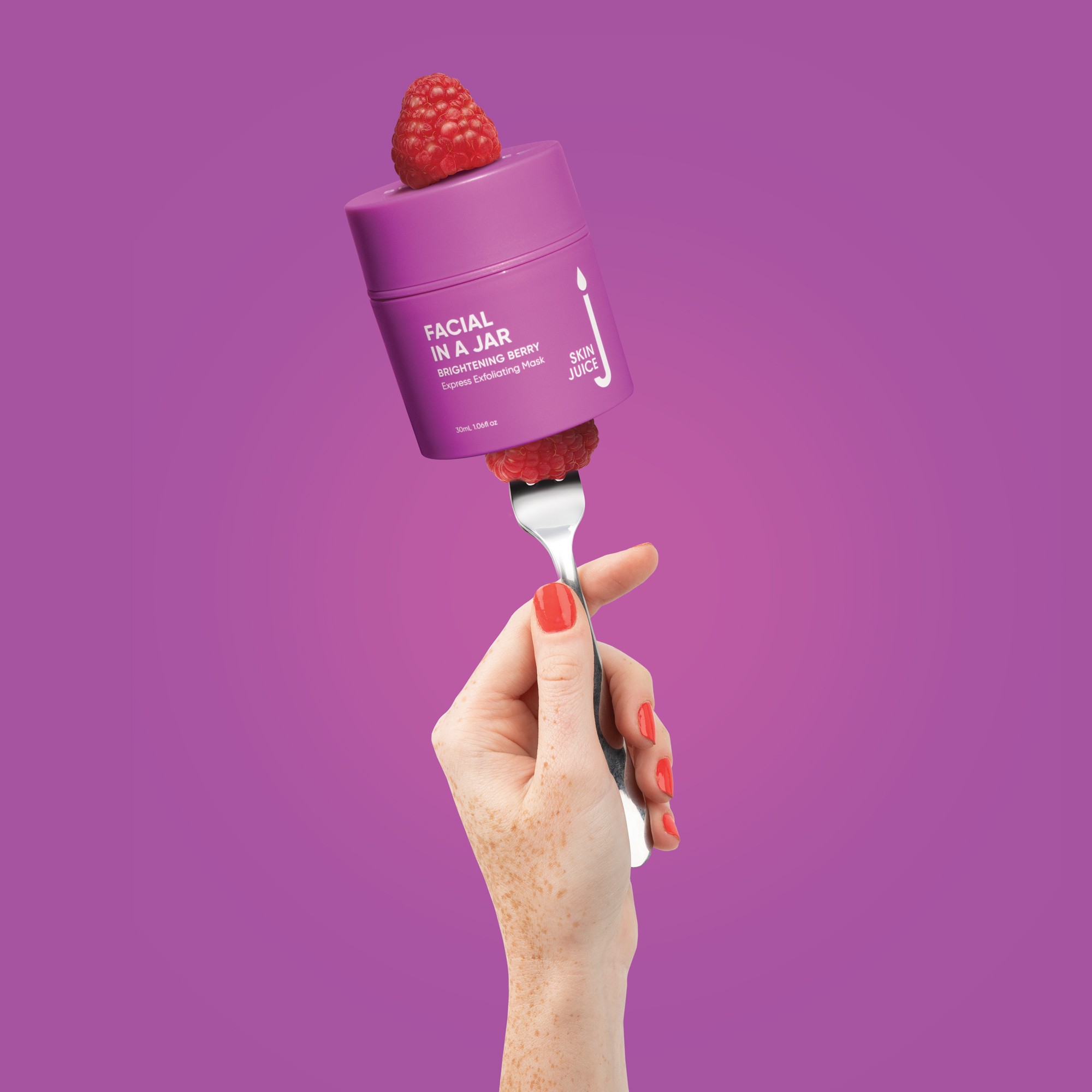 Hand holding a fork with Facial In A Jar Brightening Berry Express Exfoliating Mask for pregnancy skin condition care.