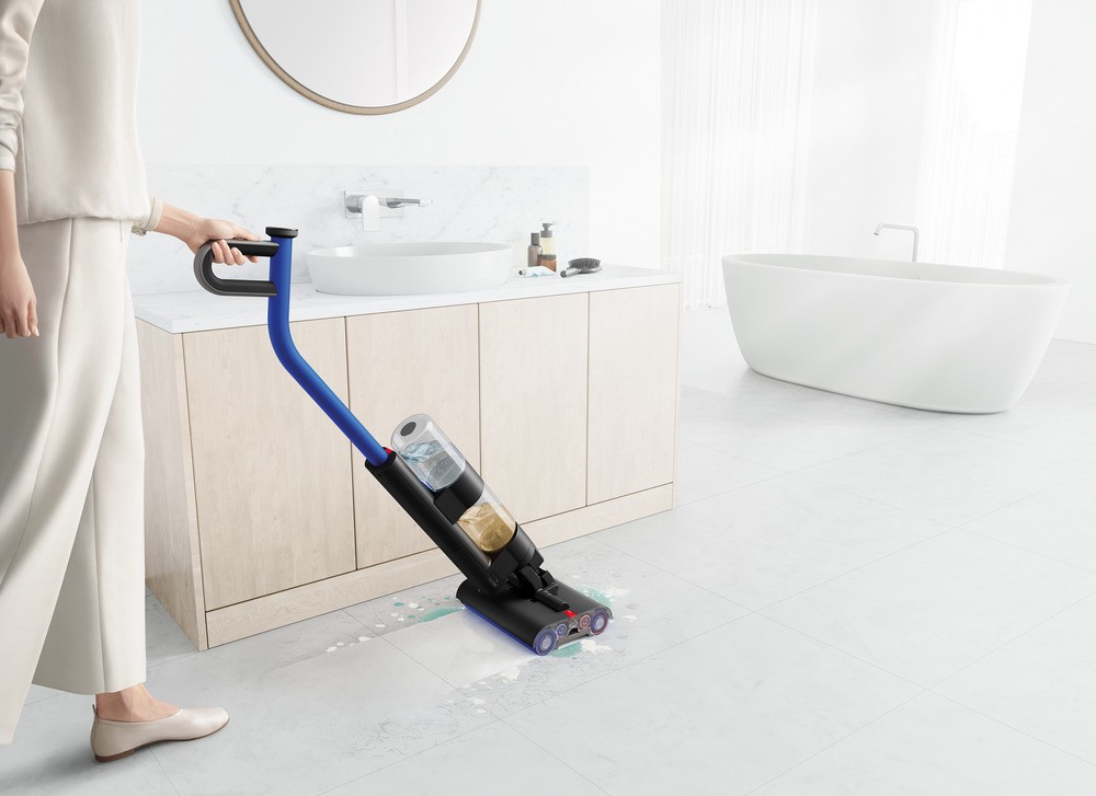 Best cleaning product showcased as a mum cleans household floor using wet vacuum cleaner.